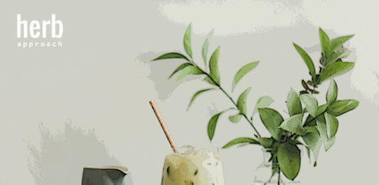 Iced matcha latte with milk pouring from pitcher, horizontal composition